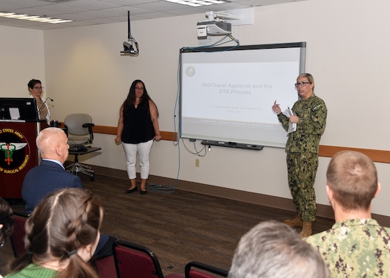 JOINT BASE SAN ANTONIO-FORT SAM HOUSTON – (May 3, 2023) – Lt. Kimberly Melin, administrative director, assigned to Naval Medical Research Unit (NAMRU) San Antonio joined by Sara BlackCloud, a financial management analyst, assigned to the Resource Management and Acquisitions Directorate, speaks about the unit’s travel approval and the Defense Travel System (DTS) process during the fifth edition of “Mission Possible,” an information-sharing event held at the Battlefield Health and Trauma (BHT) Research Institute. The purpose of “Mission Possible” is to better inform members of the command on the tactics, techniques, and procedures of the three science directorates to include the resource acquisitions and administrative directorates. NAMRU San Antonio’s mission is to conduct gap driven combat casualty care, craniofacial, and directed energy research to improve survival, operational readiness, and safety of Department of Defense personnel engaged in routine and expeditionary operations. It is one of the leading research and development laboratories for the U.S. Navy under the DoD and is one of eight subordinate research commands in the global network of laboratories operating under the Naval Medical Research Command in Silver Spring, Md. (U.S. Navy photo by Burrell Parmer, NAMRU San Antonio Public Affairs/Released)