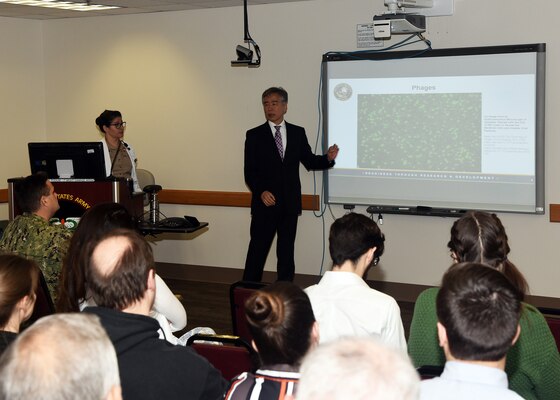 JOINT BASE SAN ANTONIO-FORT SAM HOUSTON – (May 3, 2023) – Dr. Yoon Hwang, a research microbiologist, assigned to the Craniofacial Health and Restorative Medicine Directorate of Naval Medical Research Unit (NAMRU) San Antonio, speaks on Operational Hazards during the fifth edition of “Mission Possible,” an information-sharing event held at the Battlefield Health and Trauma (BHT) Research Institute. The purpose of “Mission Possible” is to better inform members of the command on the tactics, techniques, and procedures of the three science directorates to include the resource acquisitions and administrative directorates. NAMRU San Antonio’s mission is to conduct gap driven combat casualty care, craniofacial, and directed energy research to improve survival, operational readiness, and safety of Department of Defense personnel engaged in routine and expeditionary operations. It is one of the leading research and development laboratories for the U.S. Navy under the DoD and is one of eight subordinate research commands in the global network of laboratories operating under the Naval Medical Research Command in Silver Spring, Md. (U.S. Navy photo by Burrell Parmer, NAMRU San Antonio Public Affairs/Released)