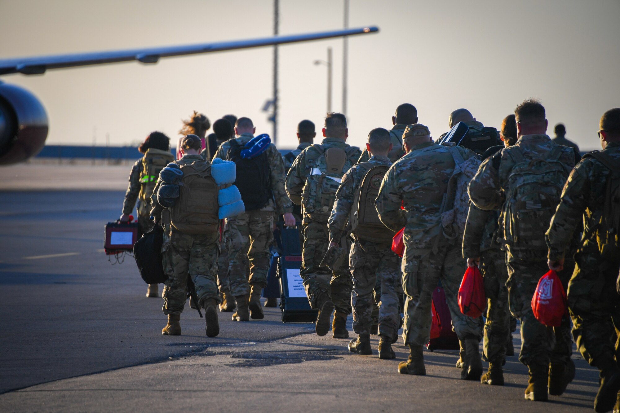 301st Fighter Wing members walk on the flight line at Naval Air Station Joint Reserve Base Fort Worth, Texas, in early April. 301 FW members and a number of F-16 Fighting Falcons deployed to U.S. Central Command’s (CENTCOM) area of operations.(U.S. Air Force photo by Tech. Sgt. Nije Hightower)