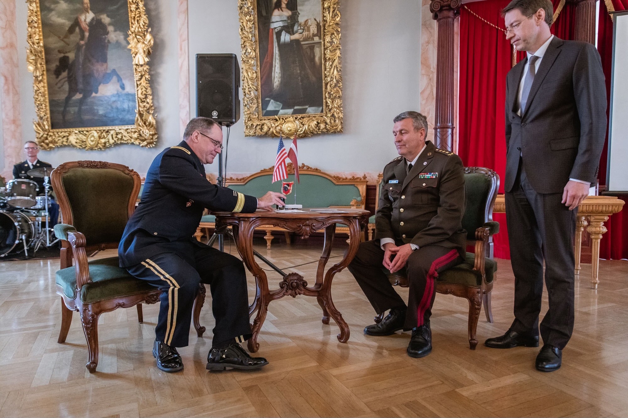 U.S. Army Maj. Gen. Paul Rogers, adjutant general of the Michigan National Guard, Lt. Gen. Leonīds Kalniņš, Latvian chief of defense, and Mārcis Vilcāns, chairman of the board for Latvia Post, perform a stamp canceling ceremony May 3, 2023, in Riga, Latvia, at an event honoring the 30th anniversary of Latvia’s defense cooperation with the Michigan National Guard under the State Partnership Program. The SPP has been instrumental in developing Latvia's defense capabilities