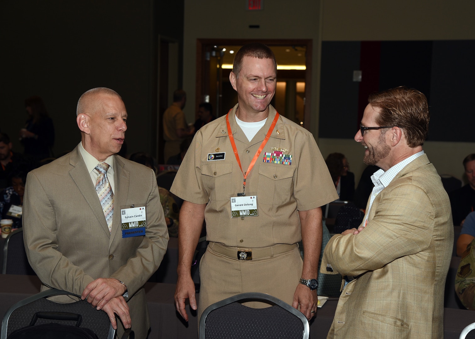 SAN ANTONIO - (May 2, 2023) – Commanding Officer Capt. Gerald DeLong, of Naval Medical Research Unit (NAMRU) San Antonio, joined by Chief Science Director Dr. Sylvain Cardin (left), speaks with an attendee during the 4th Military Medical Industry Day (MMID) hosted by VelocityTX, a subsidiary of Texas Research & Technology Foundation, the City of San Antonio, and Bexar County at the Henry B. Gonzalez Convention Center.  Attendees heard welcoming remarks from Mayor Ron Nirenberg, keynote address by Dr. Sean Biggerstaff, acting deputy assistant director, Research and Engineering, Defense Health Agency (DHA) along with various panels, to include but not limited to, “What the Military Wants” and “Military Medical Research and Development (R&D) Funding.” The MMID provides a platform for innovators and entrepreneurs to learn about military medical requirements, available funding sources to support R&D, and ways to work with the military. NAMRU San Antonio’s mission is to conduct gap driven combat casualty care, craniofacial, and directed energy research to improve survival, operational readiness, and safety of Department of Defense (DoD) personnel engaged in routine and expeditionary operations. It is one of the leading research and development laboratories for the U.S. Navy under the DoD and is one of eight subordinate research commands in the global network of laboratories operating under Naval Medical Research Command (NMRC) in Silver Spring, Md. (U.S. Navy photo by Burrell Parmer, NAMRU San Antonio Public Affairs/Released)