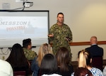 JOINT BASE SAN ANTONIO-FORT SAM HOUSTON – (May 3, 2023) – Commanding Officer Capt. Gerald DeLong of Naval Medical Research Unit (NAMRU) San Antonio speaks to personnel during the fifth edition of “Mission Possible,” an information-sharing event held at the Battlefield Health and Trauma (BHT) Research Institute. The purpose of “Mission Possible” is to better inform members of the command on the tactics, techniques, and procedures of the three science directorates to include the resource acquisitions and administrative directorates. NAMRU San Antonio’s mission is to conduct gap driven combat casualty care, craniofacial, and directed energy research to improve survival, operational readiness, and safety of Department of Defense personnel engaged in routine and expeditionary operations. It is one of the leading research and development laboratories for the U.S. Navy under the DoD and is one of eight subordinate research commands in the global network of laboratories operating under the Naval Medical Research Command in Silver Spring, Md. (U.S. Navy photo by Burrell Parmer, NAMRU San Antonio Public Affairs/Released)