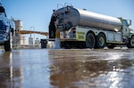 Shawn Welborn, 56th Civil Engineer Squadron assistant fire chief, releases water to simulate jet fuel spillage in a Defense Logistics Agency Energy fuel spill exercise May 4, 2023, at Luke Air Force Base, Arizona.