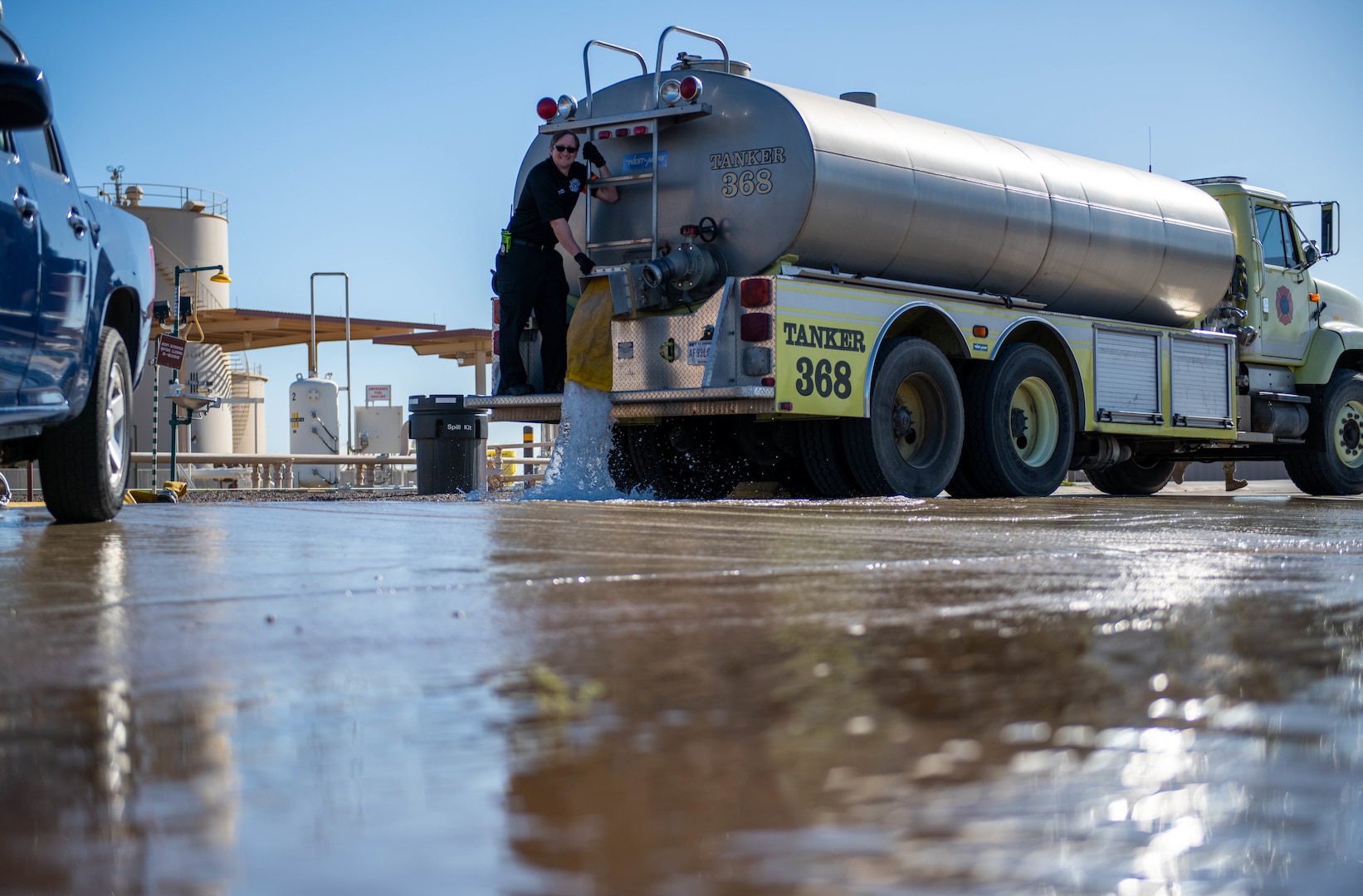 Shawn Welborn, 56th Civil Engineer Squadron assistant fire chief, releases water to simulate jet fuel spillage in a Defense Logistics Agency Energy fuel spill exercise May 4, 2023, at Luke Air Force Base, Arizona.
