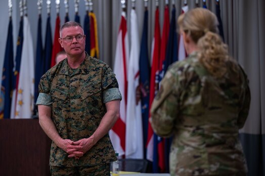  U.S. Marine Corps Master Gunnery Sgt. Scott H. Stalker, U.S. Space Command (USPACECOM) command senior enlisted leader, left, listens to U.S. Air Force Col. Karen Slocum, 9th Combat Operations Squadron (9 COS) commander, at Space Delta 1’s auditorium on Vandenberg Space Force Base, Calif., May 6, 2023. Stalker gave a mission brief of USSPACECOM and how the 9 COS plays a vital role in space operations. The 9 COS is an Air Force Reserve Command space operations unit and is the Reserve Associate unit to Space Delta 5, which augments intelligence, planning and operations at the Combined Space Operations Center. (U.S. Space Force photo by Tech. Sgt. Luke Kitterman)