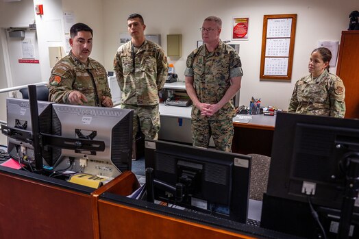  U.S. Marine Corps Master Gunnery Sgt. Scott H. Stalker, U.S. Space Command (USPACECOM) command senior enlisted leader, second from right, and gets an overview of the MILSATCOM mission the 148th Space Operations Squadron (148 SOPS) provides to the warfighter at the Vandenberg Tracking Station on Vandenberg Space Force Base, Calif., May 6, 2023. In time of emergency, by order of the Governor of California, the 148 SOPS can also provide military support to civil authorities to the California Joint Force Headquarters Operations Center (Command and Control) and Joint Incident Site Communications Capability for cyberspace. (U.S. Space Force photo by Tech. Sgt. Luke Kitterman)