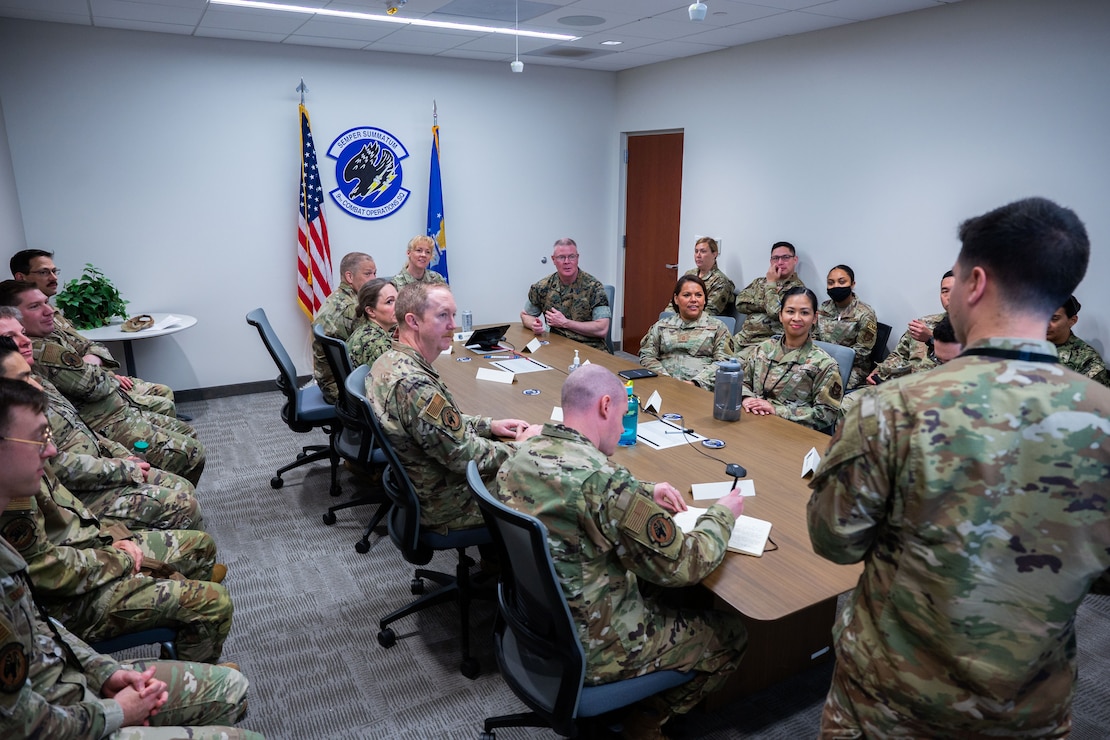 U.S. Marine Corps Master Gunnery Sgt. Scott H. Stalker, U.S. Space Command (USPACECOM) command senior enlisted leader, middle, sits with members of the 9th Combat Operations Squadron (9 COS) and other USSPACECOM attendees during a 9 COS mission brief at the Combined Force Space Component Command headquarters on Vandenberg Space Force Base, Calif., May 6, 2023. The 9 COS is an Air Force Reserve Command space operations unit and is the Reserve Associate unit to Space Delta 5, which augments intelligence, planning and operations at the Combined Space Operations Center. (U.S. Space Force photo by Tech. Sgt. Luke Kitterman)