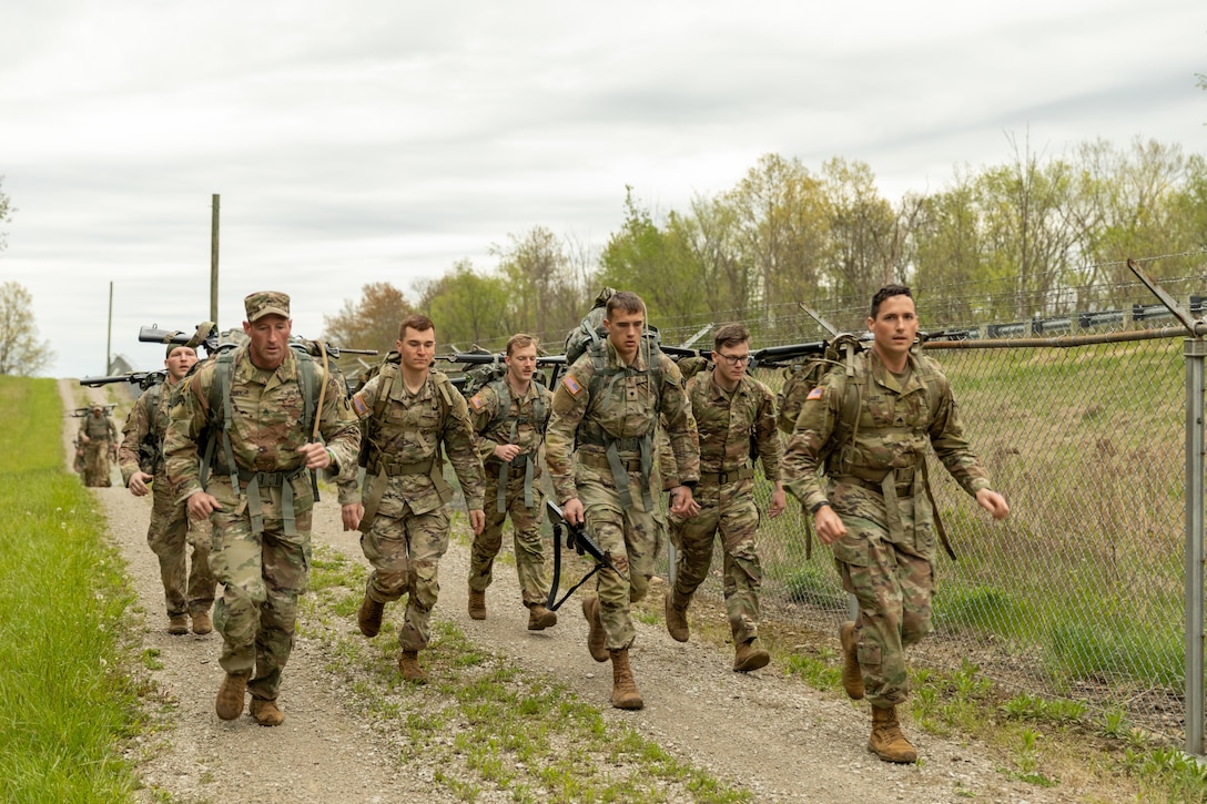 Competitors begin the 12-mile ruck march at the Region IV Army National Guard Best Warrior Competition at Camp James A. Garfield Joint Military Training Center, Newton Falls, Ohio, May 7, 2023. Guard members from Indiana, Iowa, Minnesota, Wisconsin, Michigan, Ohio and Illinois competed in land navigation, marksmanship, weapons skills, medical and radio skills and an appearance board, among other events.