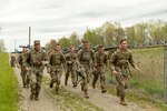 Competitors begin the 12-mile ruck march at the Region IV Army National Guard Best Warrior Competition at Camp James A. Garfield Joint Military Training Center, Newton Falls, Ohio, May 7, 2023. Guard members from Indiana, Iowa, Minnesota, Wisconsin, Michigan, Ohio and Illinois competed in land navigation, marksmanship, weapons skills, medical and radio skills and an appearance board, among other events.