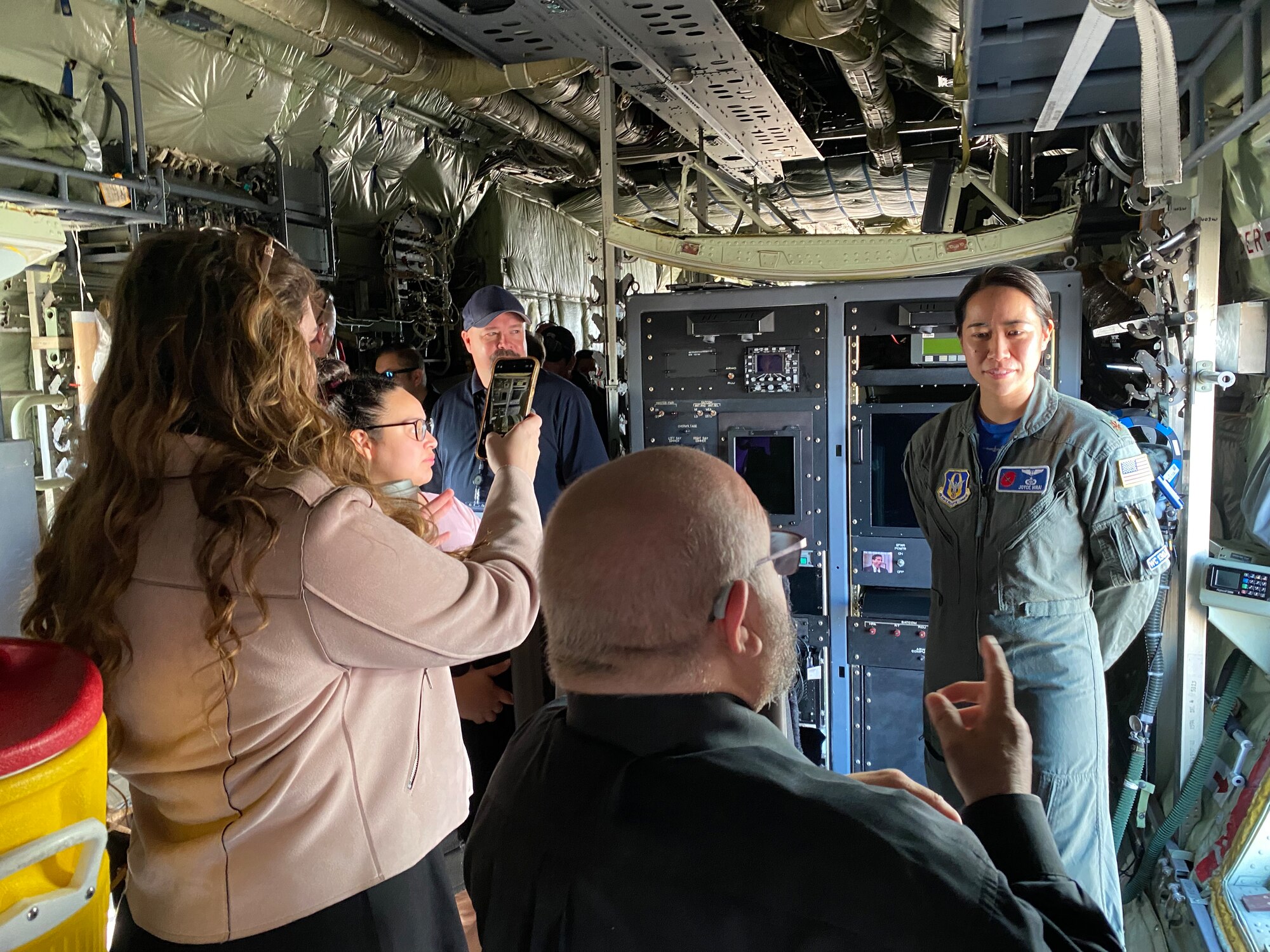 Maj. Joyce Hirai explains her job to people touring the WC-130J Super Hercules.