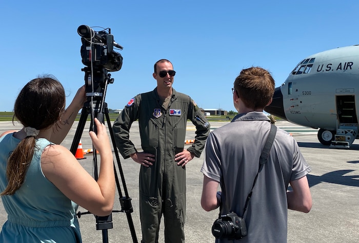 Capt. Kyle McElhaney gives an interview to media members by the WC-130J Super Hercules.