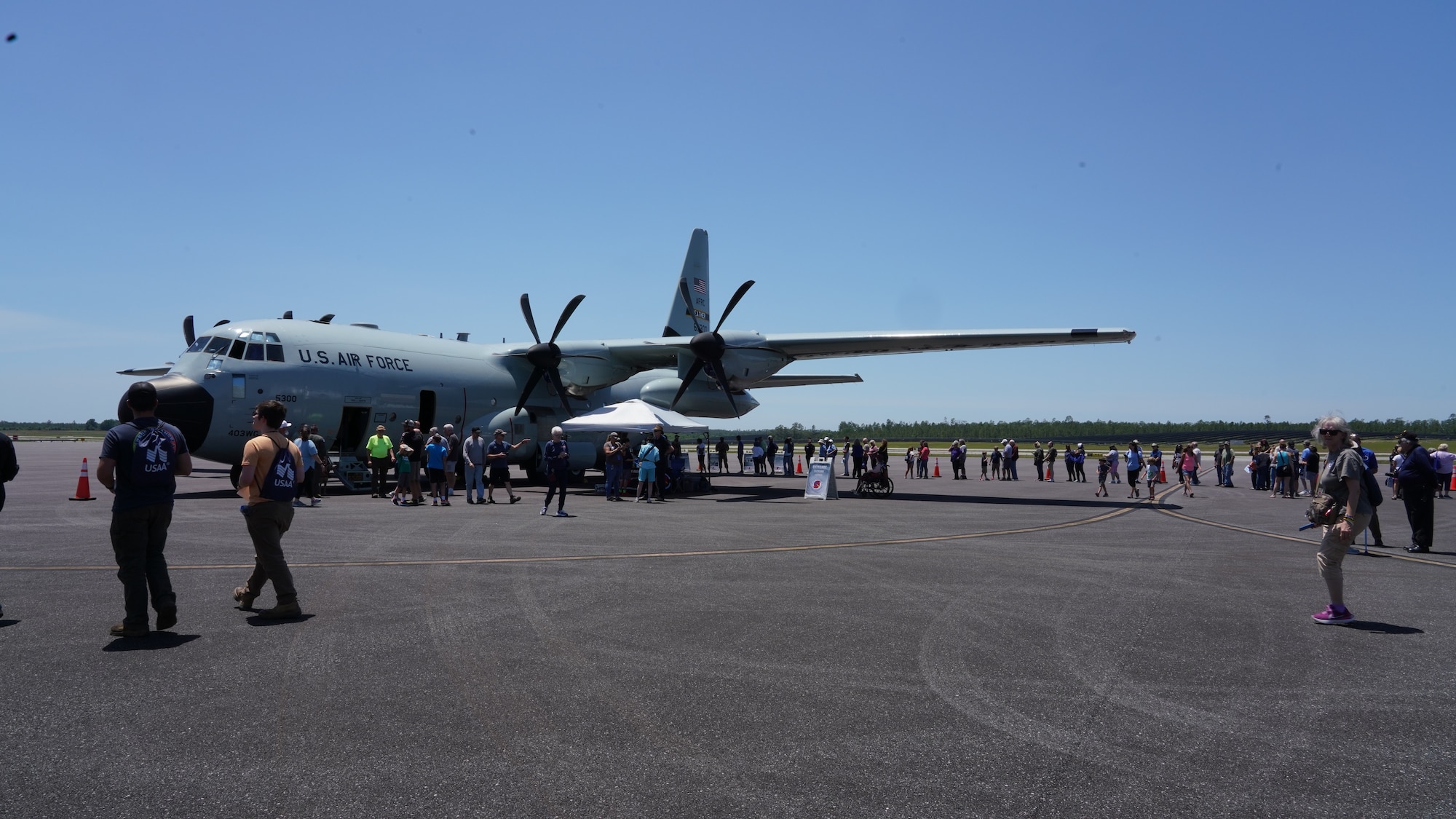 A line of people wait to tour the WC-130J Super Hercules flown into tropical storms and hurricanes.