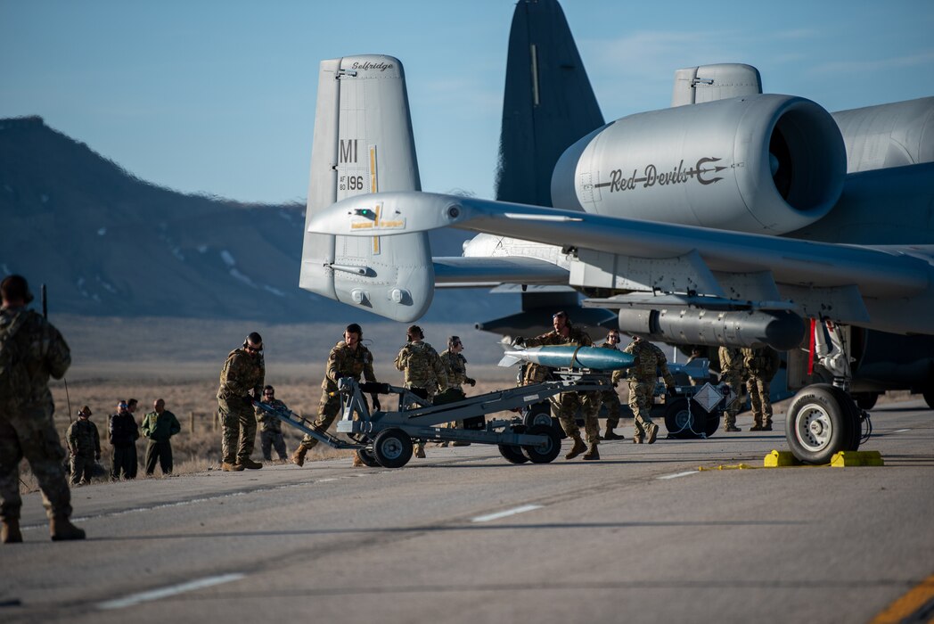 Airmen with the 127th Fighter Wing conduct an Integrated Combat Turn weapons reload on one of their A-10 Thunderbolt IIs on Highway 287 during Exercise Agile Chariot, April 30, 2023, honing capabilities linked to Agile Combat Employment. Instead of relying on large, fixed bases and infrastructure, ACE employs smaller, more dispersed locations and teams to rapidly move aircraft, pilots and other personnel as needed. Under ACE, millions of miles of public roads can serve as functional runways with Forward Arming and Refueling Points when necessary. (U.S. Air National Guard photo by Master Sgt. Phil Speck)