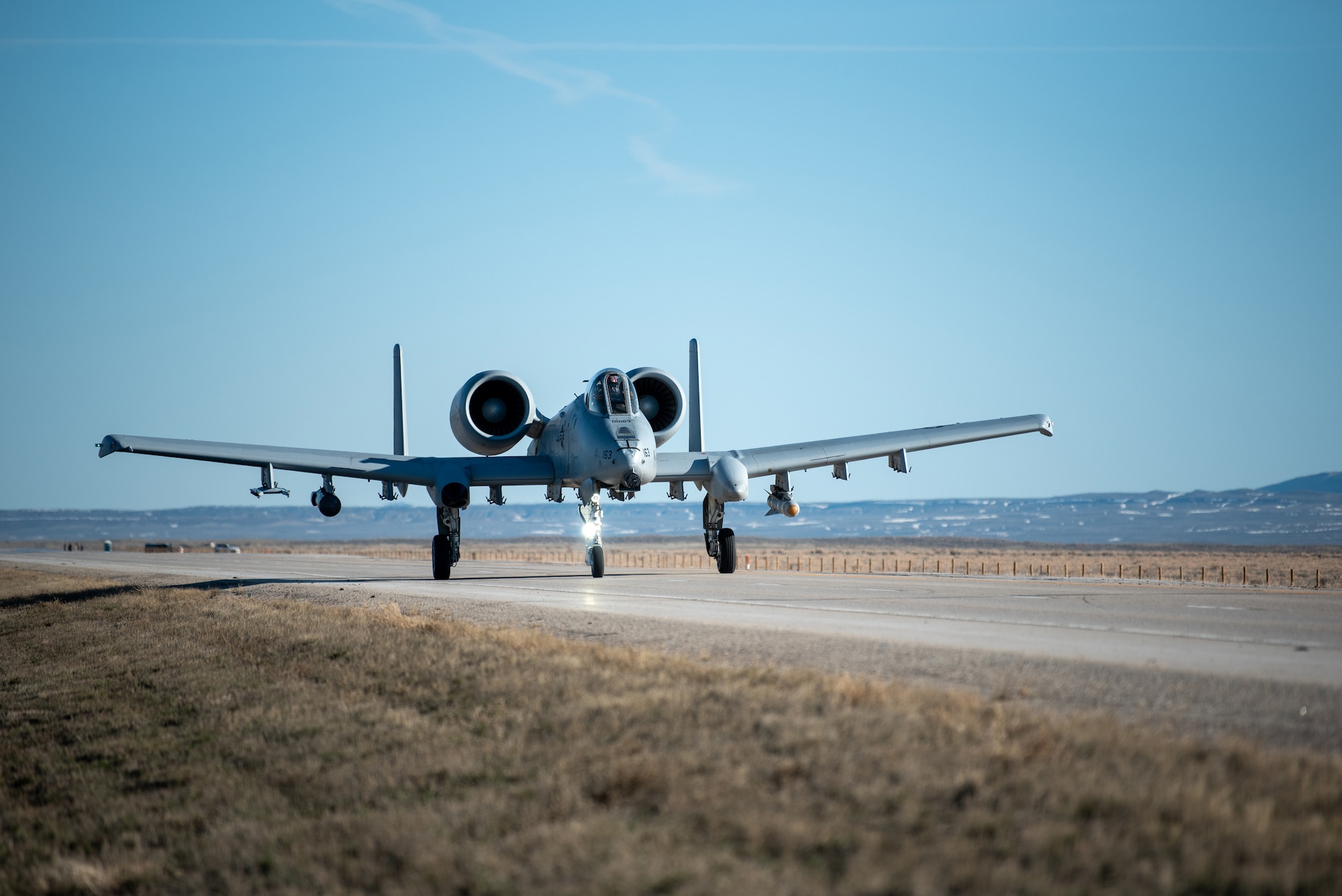 An A-10 Thunderbolt II lands on Highway 287 in Wyoming during Exercise Agile Chariot on April 30, 2023, honing capabilities linked to Agile Combat Employment. Instead of relying on large, fixed bases and infrastructure, ACE employs smaller, more dispersed locations and teams to rapidly move aircraft, pilots and other personnel as needed. Under ACE, millions of miles of public roads can serve as functional runways with Forward Arming and Refueling Points when necessary. (U.S. Air National Guard photo by Master Sgt. Phil Speck)