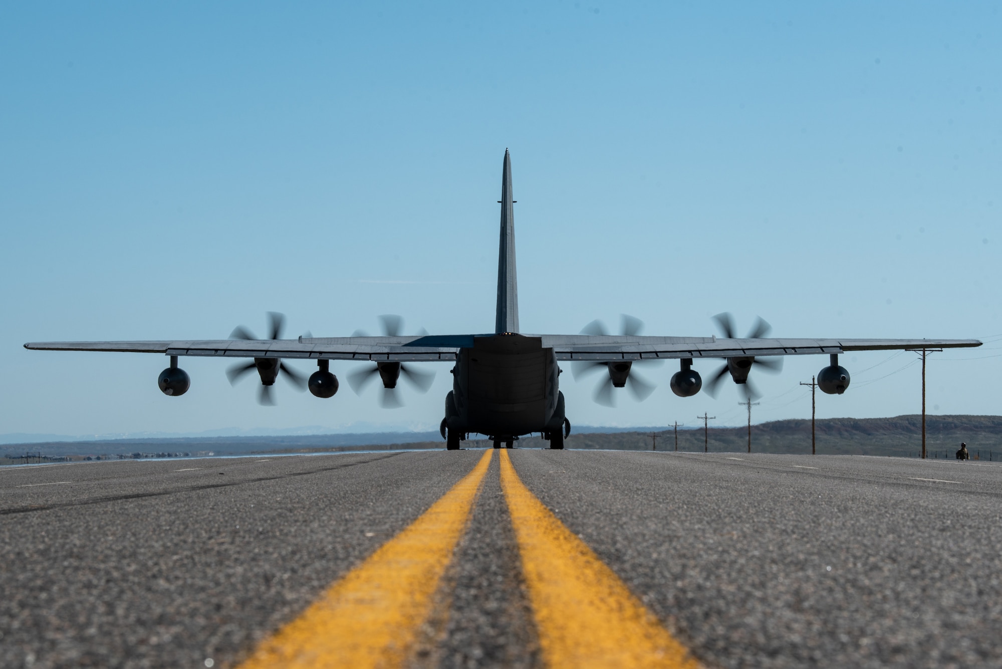 An MC-130J Commando II from the 1st Special Operations Wing prepares to offload a pair of MH-6M Little Birds on Highway 789 during Exercise Agile Chariot near Riverton, Wyoming, May 2, 2023. Agile Chariot tested Agile Combat Employment capabilities, including using smaller, more dispersed locations and teams to rapidly move and support aircraft, pilots and other personnel wherever they’re needed. (U.S. Air National Guard photo by Master Sgt. Phil Speck)