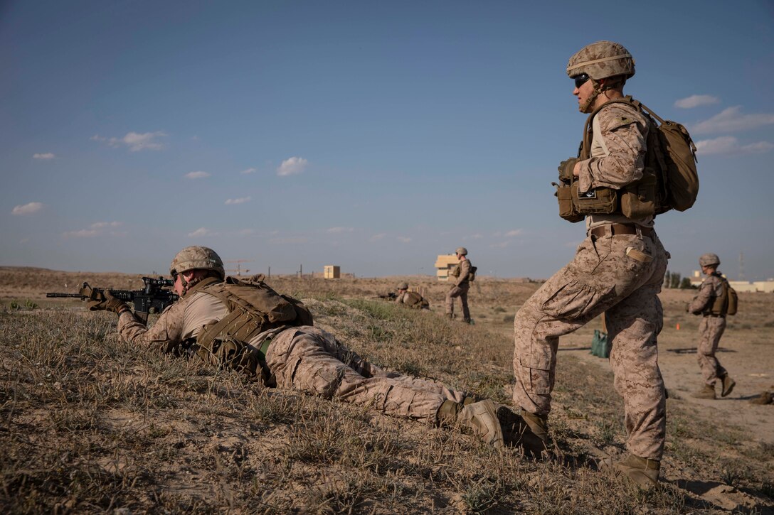 U.S. Marine Corps Cpl. Jake Riddle acts as a position safety officer for Lance Cpl. Christopher Andrade, both riflemen with Fleet Anti-terrorism Security Team Central Command, while he aims down range during buddy rush drills at Camp Kazma, Kuwait, March 11, 2019. Buddy rushes enhance their ability to react and eliminate targets when engaged on a patrol. FASTCENT provides expeditionary anti-terrorism and security forces to embassies, consulates and other vital national assets throughout the U.S. Central Command area of responsibility. (U.S. Marine Corps photo by Cpl. Alina Thackray)
