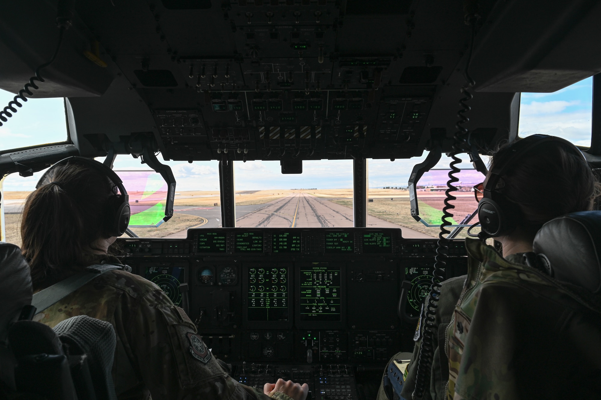 two Female airmen take-off in a C-130J Super Hercules