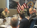 men around a table in discussion