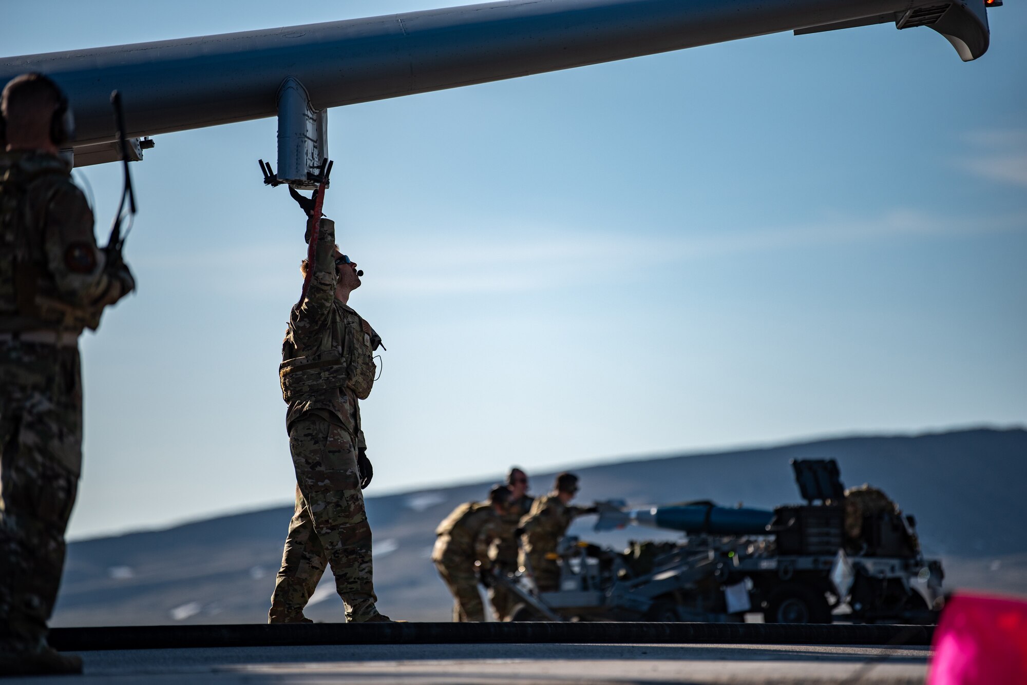 Airmen with the 127th Fighter Wing conduct an Integrated Combat Turn weapons reload on one of their A-10 Thunderbolt IIs on Highway 287 in Wyoming during Exercise Agile Chariot, April 30, 2023, honing capabilities linked to Agile Combat Employment. Instead of relying on large, fixed bases and infrastructure, ACE employs smaller, more dispersed locations and teams to rapidly move aircraft, pilots and other personnel as needed. Under ACE, millions of miles of public roads can serve as functional runways with Forward Arming and Refueling Points when necessary. (U.S. Air National Guard photo by Master Sgt. Phil Speck)