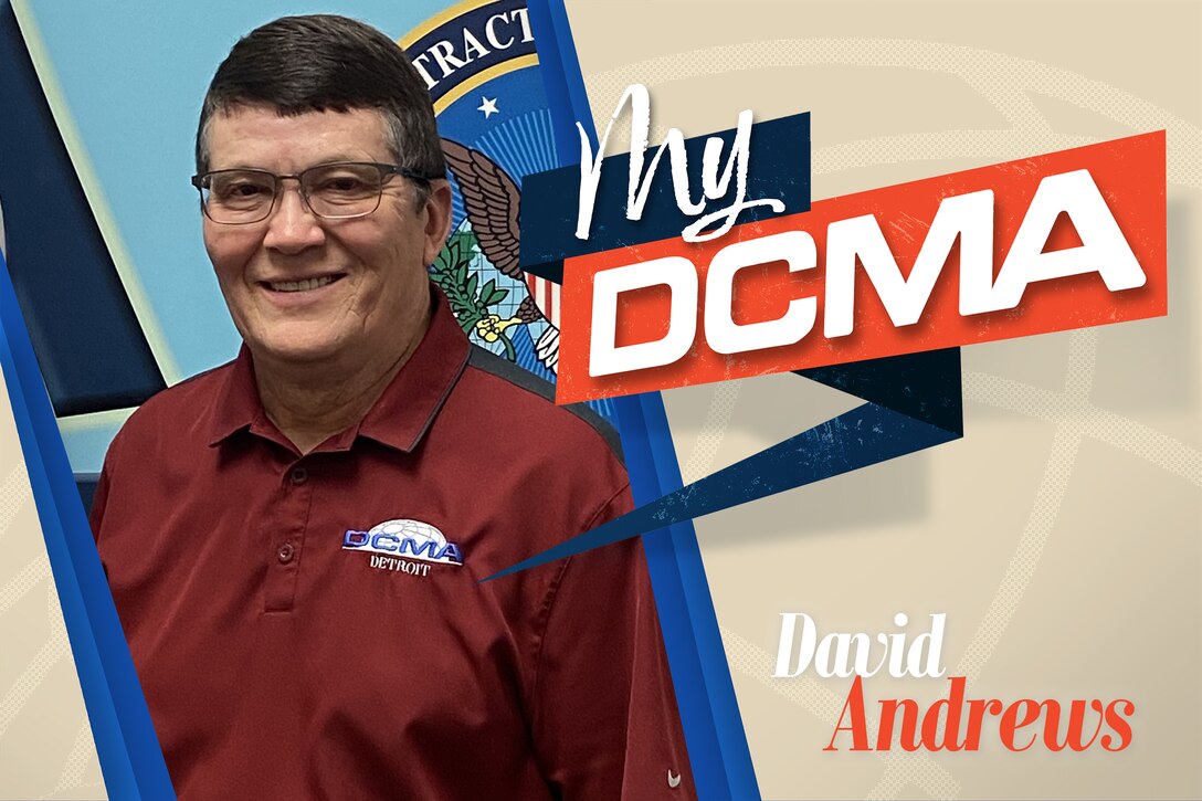 A smiling man wearing glasses has on a red shirt with the DCMA logo