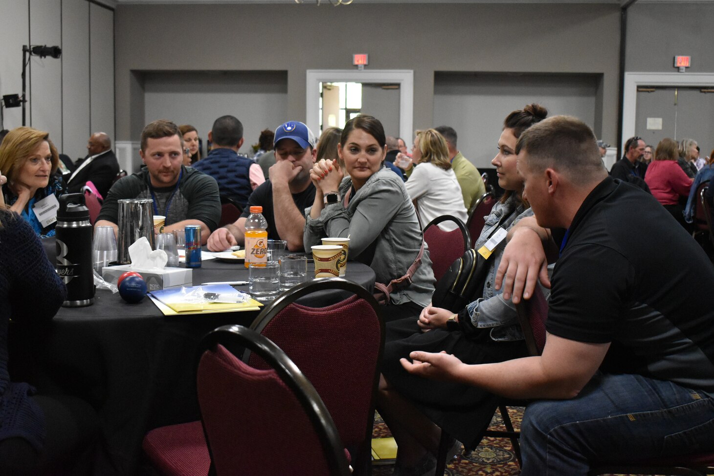A group of Sailors and their families discuss operational stress control during a tabletop exercise conducted at the Returning Warrior Workshop (RWW).