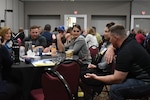 A group of Sailors and their families discuss operational stress control during a tabletop exercise conducted at the Returning Warrior Workshop (RWW) in Nashville, Tennessee. Returning Warrior Workshops are a component of the Yellow Ribbon Reintegration Program designed to honor service members and their families while helping the transition of Active and Reserve Component Sailors returning from deployments and individual augments.