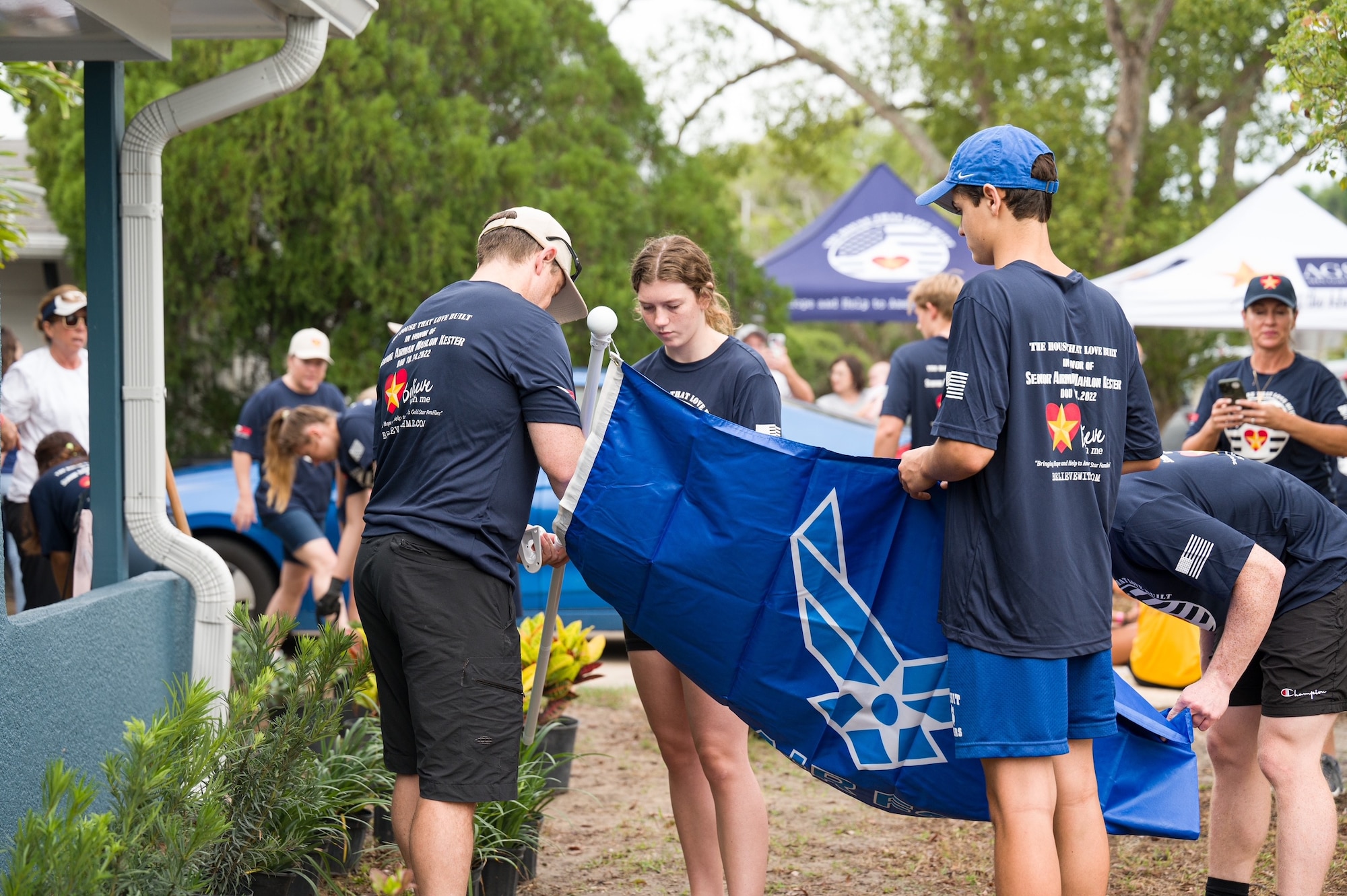 Volunteers mount a U.S. Air Force flag.