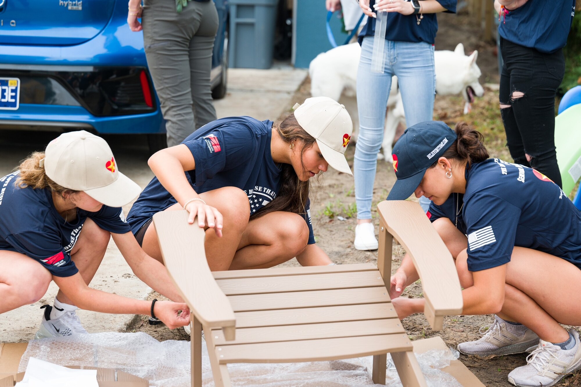 Volunteers construct outdoor furniture