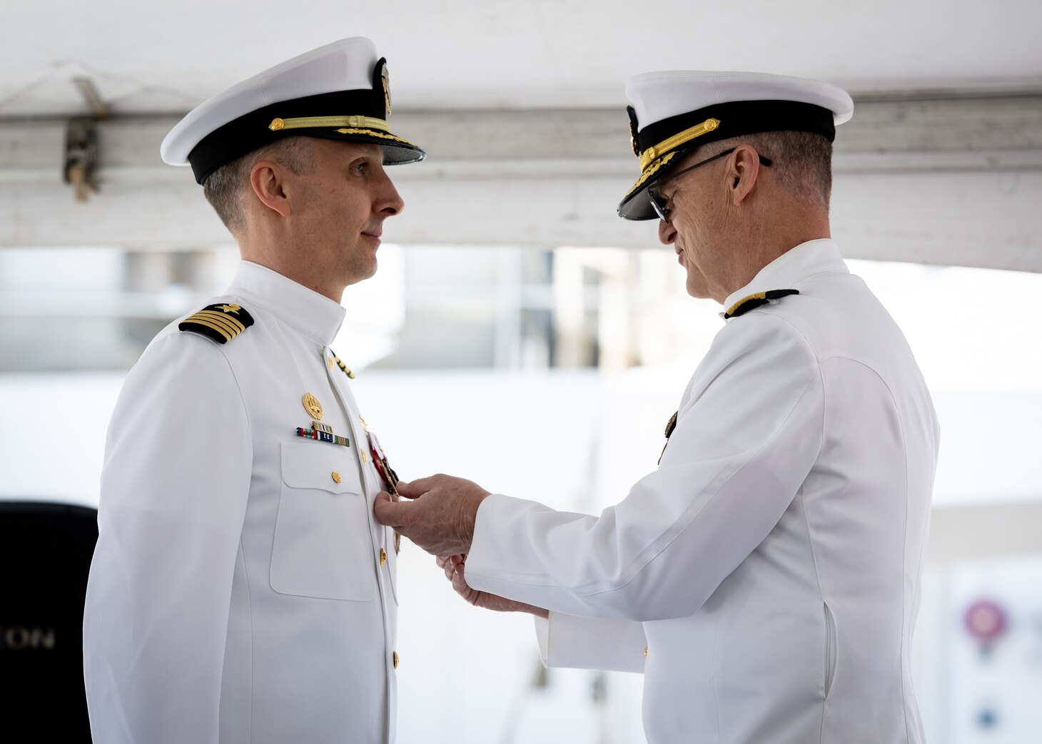 Military Sealift Command’s leadership in the Atlantic changed hands, when Navy Capt. James A. Murdock relieved Navy Capt. Daniel E. Broadhurst as commander of Norfolk-based Military Sealift Command Atlantic (MSC Atlantic) during a change of command ceremony held aboard Navy hospital ship USNS Comfort (T-AH-20) in Naval Station Norfolk April 13, 2023. In this picture, Rear Adm. Michael A. Wettlaufer, commander of MSC, presents Broadhurst with the Legion of Merit pin.