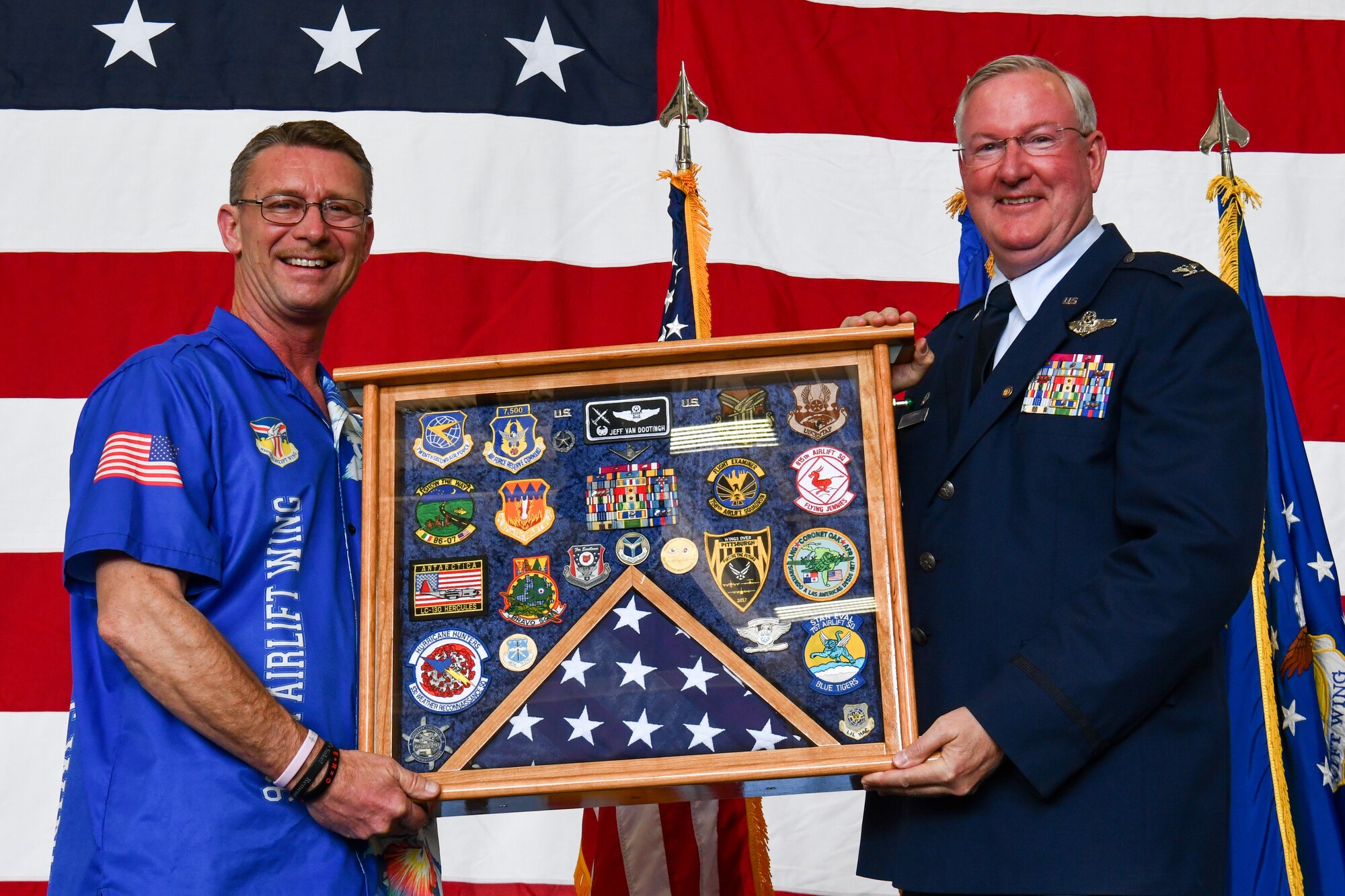 Retired Senior Master Sgt. Jim Samples presents a shadow box to Col. Jeff Van Dootingh, the commander of the 910th Airlift Wing, May 6, 2023, at Youngstown Air Reserve Station, Ohio.