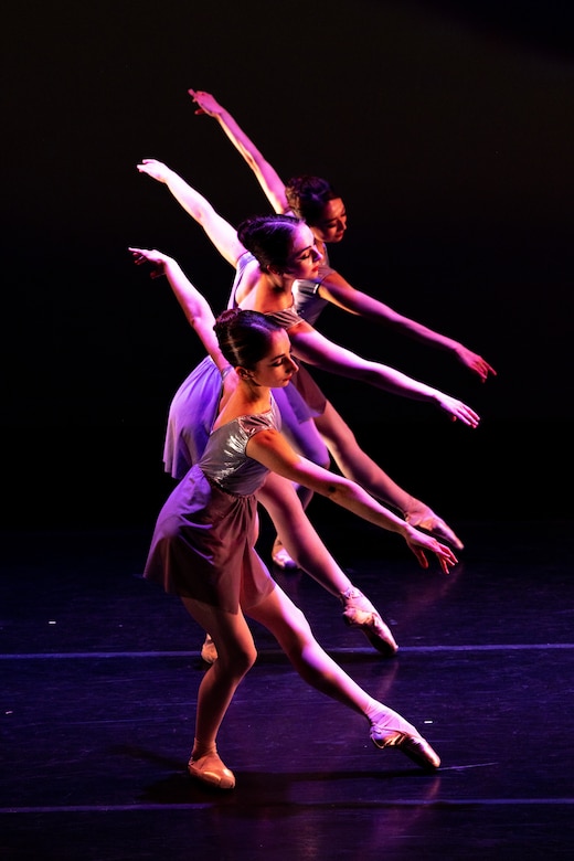 Ballerinas perform on stage.