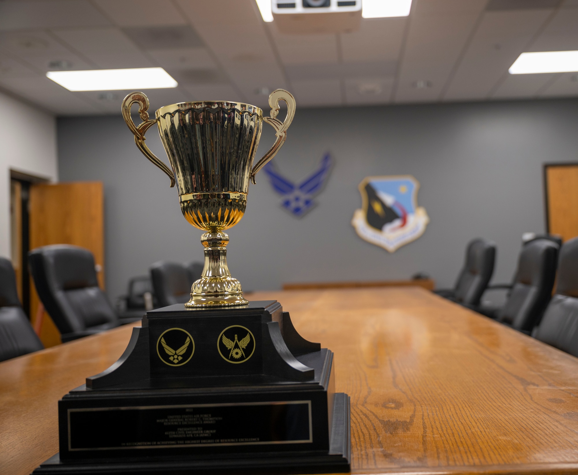 A photo is taken of the Maj. Gen. Robert C. Thompson Award. This award recognizes the CE unit which achieved the highest degree of recourse excellence within the U.S. Air Force by offering the most outstanding products and services to its customers.