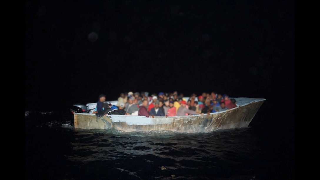 Coast Guard cutter Joseph Napier interdicts a grossly overloaded makeshift migrant vessel with 64 people northwest of Aguadilla, Puerto Rico, May 7, 2023.  The group was part of 129 other migrants, who were interdicted during five separate irregular maritime migration events in the Mona Passage between May 5 and May 8, 2023. (U.S. Coast Guard photo)