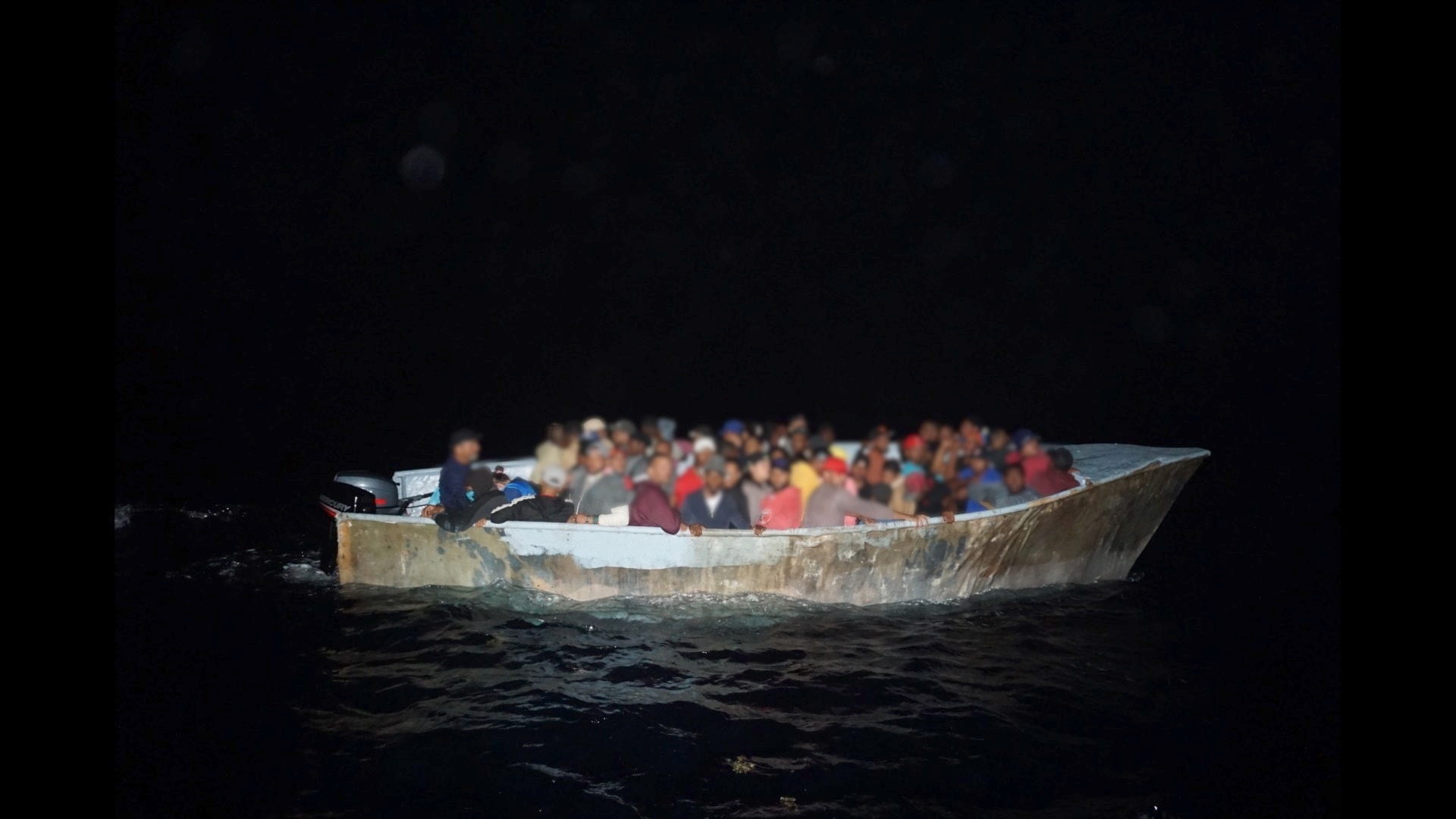 Coast Guard cutter Joseph Napier interdicts a grossly overloaded makeshift migrant vessel with 64 people northwest of Aguadilla, Puerto Rico, May 7, 2023.  The group was part of 129 other migrants, who were interdicted during five separate irregular maritime migration events in the Mona Passage between May 5 and May 8, 2023. (U.S. Coast Guard photo)