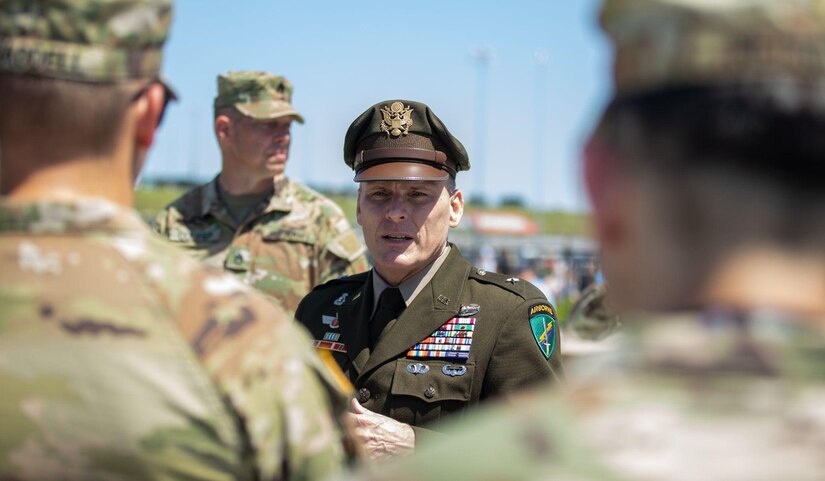 U.S. Army Brig. Gen. Dean Thompson, the commanding general of 353rd Civil Affairs Command, speaks to 1st Infantry Division Soldiers prior to a reenlistment ceremony held at Kansas Speedway, Kansas City, Kan., May 7, 2023. Thompson officiated the ceremony prior to the start of the AdventHealth 400 NASCAR race, where Soldiers from 1st Inf. Div. reenlisted in the middle of the speedway. (U.S. Army photo by Spc. Kenneth Barnet)