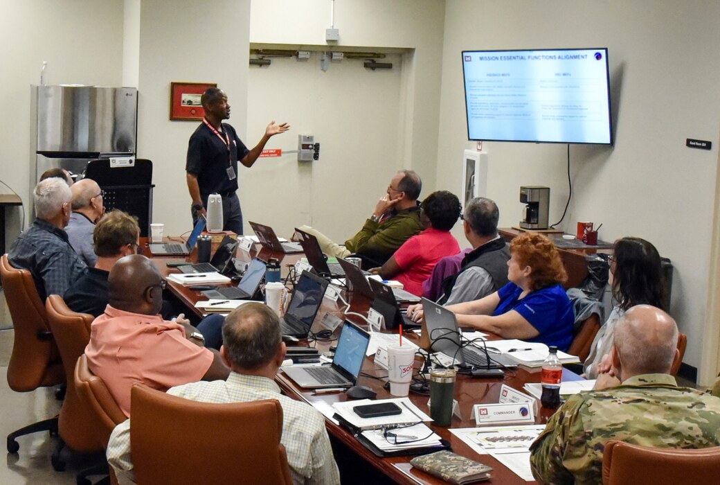 Charles Carson, Huntsville Center emergency manager, goes over the Center's Continuity of Operations Plan (COOP) with members of the Emergency Relocation Group during a COOP exercise April 12. (Photo by Kristen Bergeson)