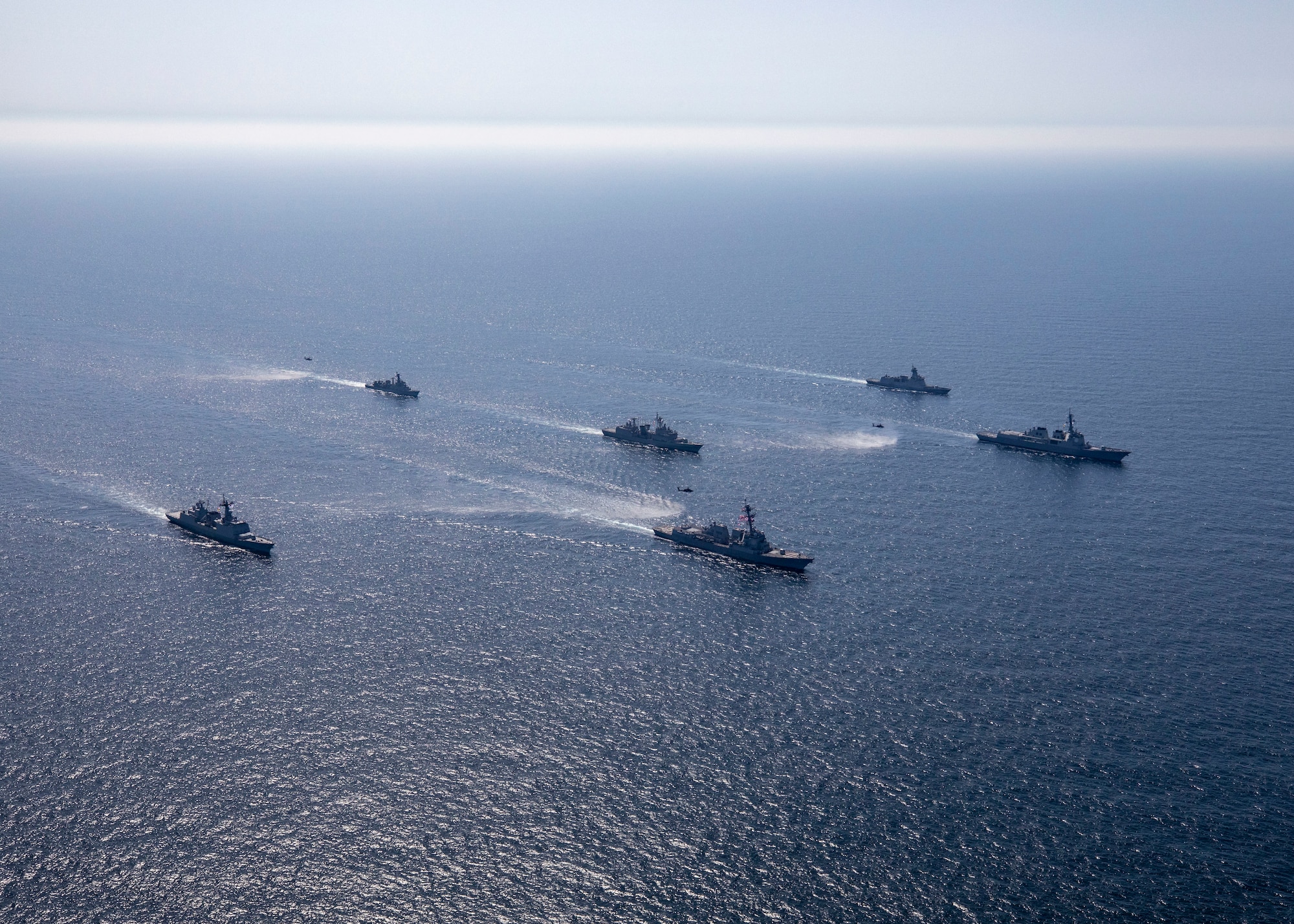 230427-N-CD453-1098 YELLOW SEA (April 27, 2023) U.S. Army AH-64D/E Apache helicopters attached to the 5th Squadron, 17th Cavalry Regiment, 2nd Combat Aviation Brigade, fly alongside Arleigh Burke-class guided-missile destroyer USS John Finn (DDG 113) as the ship sails in formation with Republic of Korea Navy ships Sejong the Great-class guided-missile destroyer ROKS Sejong the Great (DDG 991), Daegu-class frigate ROKS Seoul (FFG-821), Gwangaetto the Great-class multipurpose destroyer ROKS Eulji Mundeok (DDH-972), Chungmugong Yi Sun-sin-class multipurpose destroyer ROKS Choe Yeong (DDH 981), and Ulsan-class frigate ROKS Cheongju, during Maritime Counter Special Operations Exercise (MCSOFEX) in the Yellow Sea, April 27. John Finn is assigned to Commander, Task Force 71/Destroyer Squadron (DESRON) 15, the Navy’s largest forward-deployed DESRON and U.S. 7th Fleet’s principal surface force. (U.S. Navy photo by Mass Communication Specialist 2nd Class Samantha Oblander)