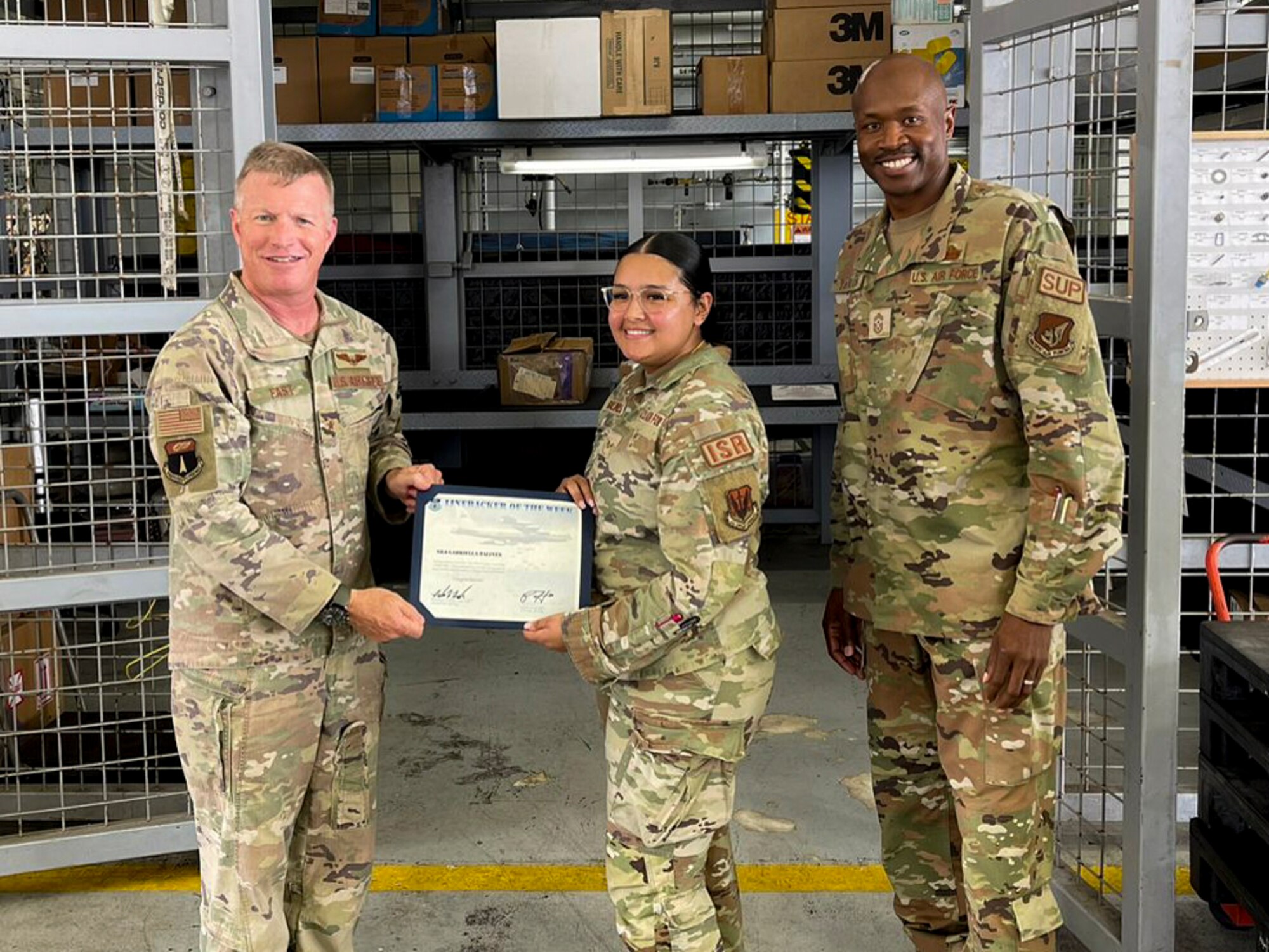U.S. Air Force Senior Airman Gabriella Balines, a decentralized material support specialist assigned to the 4th Reconnaissance Squadron, receives the Linebacker of the Week Award from U.S. Air Force Brig. Gen. Paul Fast, commander of the 36th Wing, and U.S. Air Force Chief Master Sgt. Nicholas Taylor, the command chief of the 36th Wing, at Andersen Air Force Base, Guam, May 3, 2023. The Team Andersen Linebacker of the Week recognizes outstanding enlisted, officer, civilian and total force personnel who have had an impact on achieving Team Andersen’s mission, vision and priorities. (Courtesy photo)