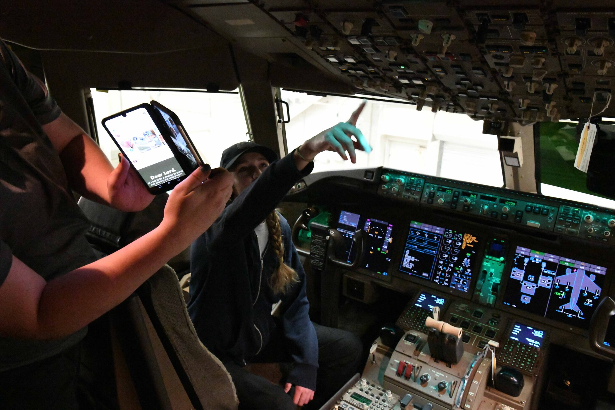 Amanda Olson, 97th Aircraft Maintenance Squadron KC-46 Pegasus crew chief, showcases the flight controls of a KC-46 to students from Hill Field Elementary School in Clearfield, Utah over livestream video call during a STEMtoSky event at Altus Air Force Base, Oklahoma, May 1, 2023. Crew chiefs are responsible for maintaining aircraft during launch, recovery and inspection. (U.S. Air Force photo by Airman 1st Class Miyah Gray)