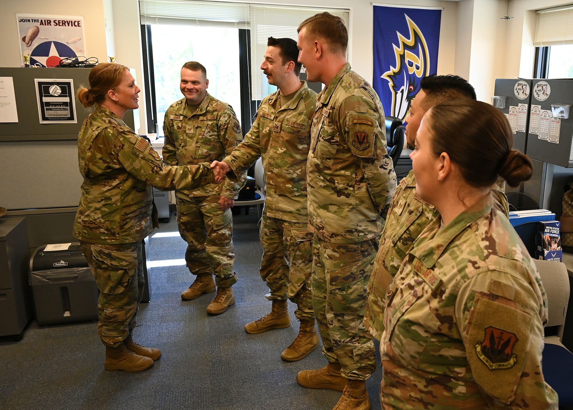 U.S. Air Force Brig. Gen. Jori Robinson, 175th Wing commander, coins members of the 175th Wing recruiting team at Martin State Air National Guard Base, Middle River, Md., on May 6, 2023, for being awarded the Air Force Recruiting Service Top III Chief Master Sgt. Brad W. Esposito Team Leadership Award for their accomplishments in the first quarter of fiscal year 2023.