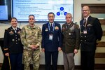 Gen. Hiroaki Uchikura, Japan Air Self-Defense Force chief of staff, center, poses for a photo with Joint Task Force-Space Defense and U.S. Space Command leaders at the JTF-SD Commercial Operations Cell (JCO) facility during Space Symposium 38 in Colorado Springs, Colo., April 20, 2023. The JCO is an extension of the National Space Defense Center operations floor, and it leverages commercial providers to provide diverse, timely Space Domain Awareness in direct support of the NSDC’s core protect-and-defend mission. (U.S. Space Force photo by Tiana Williams)
