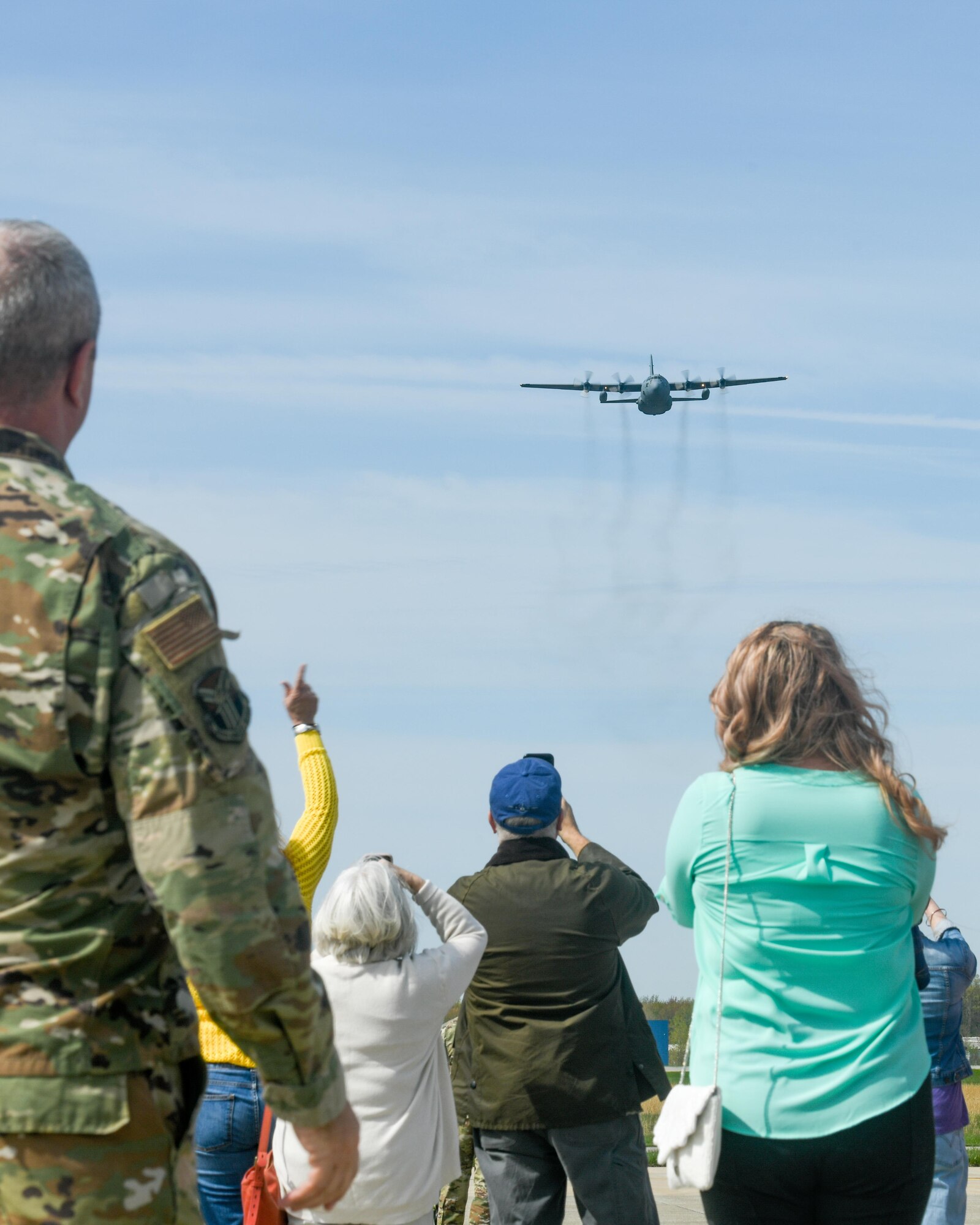 Family and friends of Col. Jeff Van Dootingh, the commander of the 910th Airlift Wing, watch as his “fini-flight” passes over them, May 6, 2023, at Youngstown Air Reserve Station, Ohio.