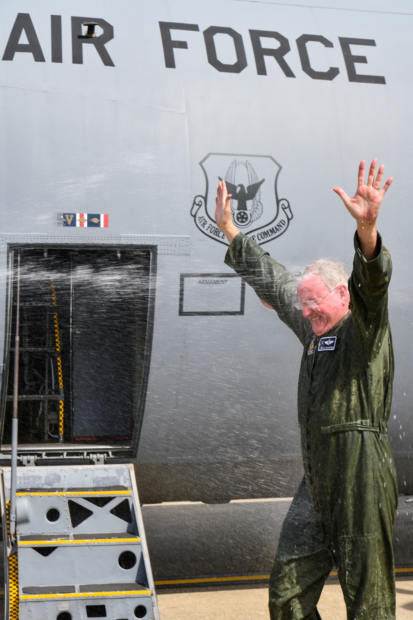 Col. Jeff Van Dootingh, the commander of the 910th Airlift Wing, is sprayed with water at Youngstown Air Reserve Station, Ohio, on May 6, 2023, after his “fini-flight” aboard a C-130H Hercules aircraft.