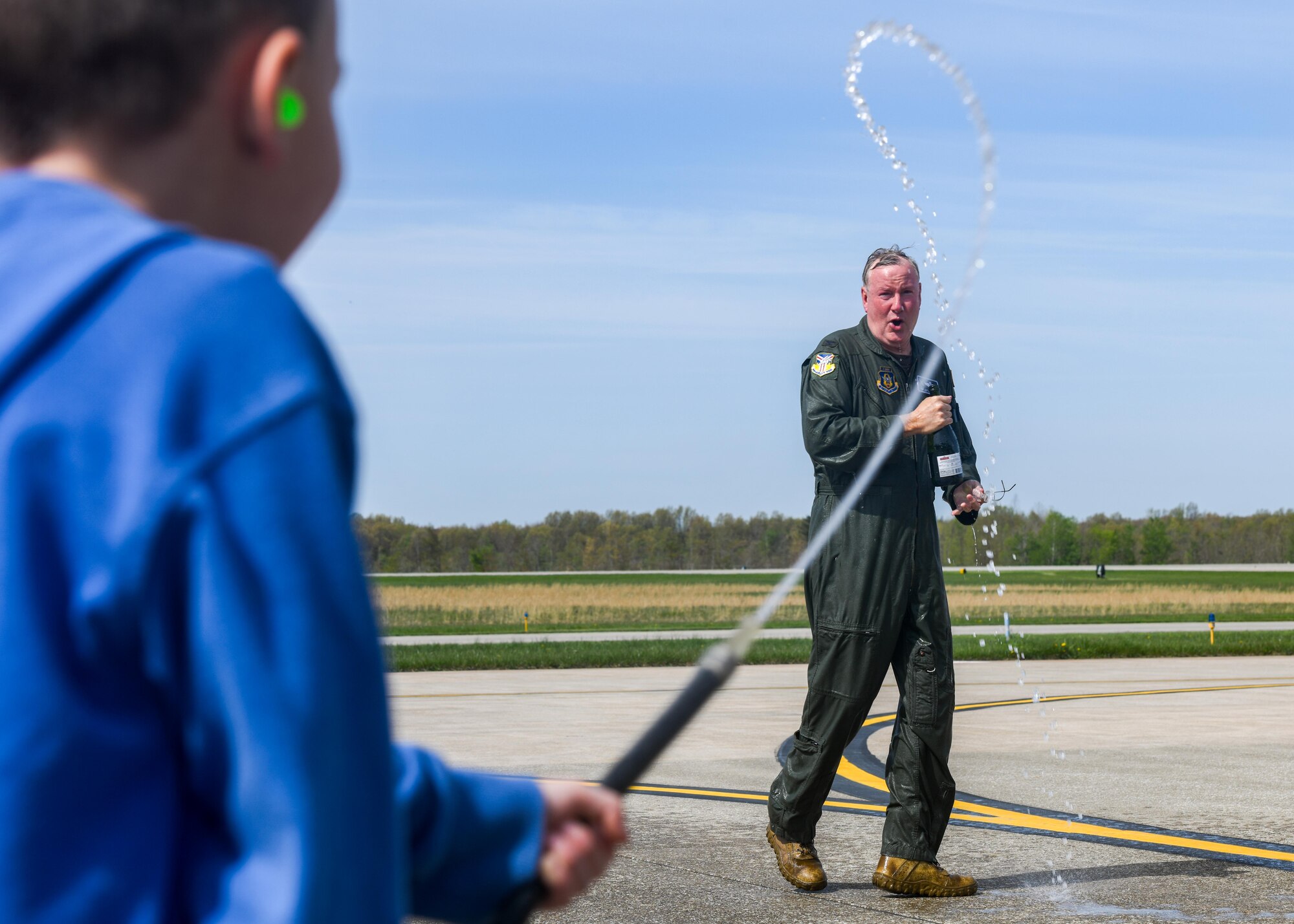Col. Jeff Van Dootingh, the commander of the 910th Airlift Wing, is sprayed with water at Youngstown Air Reserve Station, Ohio, on May 6, 2023, after his “fini-flight” aboard a C-130H Hercules aircraft.