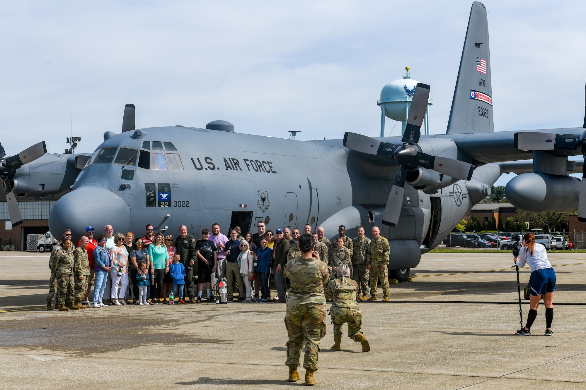 Col. Jeff Van Dootingh, the commander of the 910th Airlift Wing, poses for a photo with his friends and family, May 6, 2023, in front of the C-130H Hercules aircraft he had just flown his “fini-flight” in.