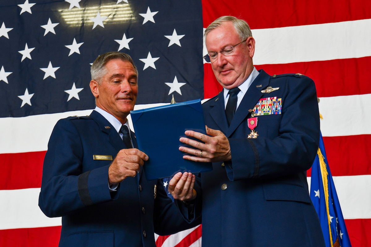 Brig Gen. Bill Whittenberger, the mobilization assistant to the commander of the Air Force Special Operations Command, and Col. Jeff Van Dootingh, the commander of the 910th Airlift Wing, look upon Van Dootingh’s retirement certificate during his ceremony, May 6, 2023, at Youngstown Air Reserve Station, Ohio.