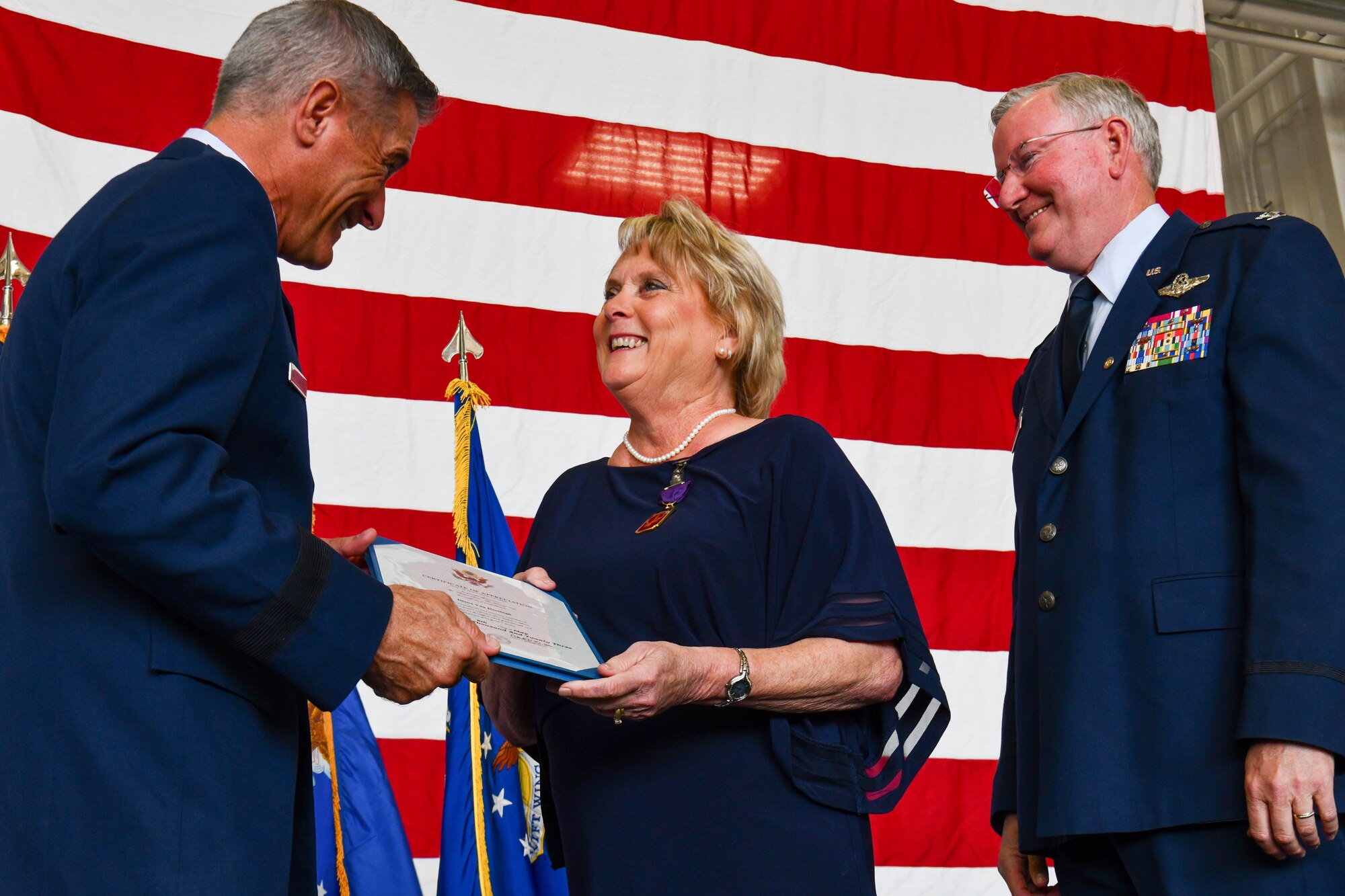 Brig Gen. Bill Whittenberger, the mobilization assistant to the commander of the Air Force Special Operations Command, awards the military spouse medal and spouse certificate of appreciation to Mrs. Diana Van Dootingh the wife of Col. Jeff Van Dootingh, the commander of the 910th Airlift Wing, May 6, 2023, at Youngstown Air Reserve Station, Ohio.