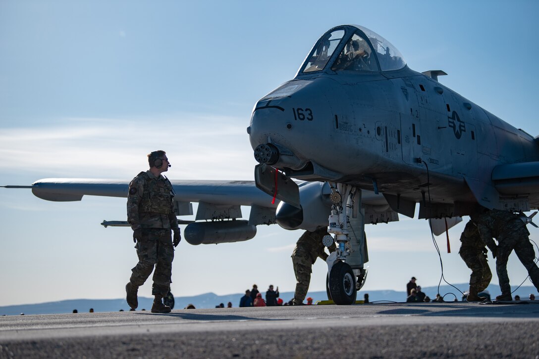 Airmen with the 127th Fighter Wing conduct an Integrated Combat Turn weapons reload on one of their A-10 Thunderbolt IIs on Highway 287 in Wyoming during Exercise Agile Chariot, April 30, 2023, honing capabilities linked to Agile Combat Employment Instead of relying on large, fixed bases and infrastructure, ACE employs smaller, more dispersed locations and teams to rapidly move aircraft, pilots and other personnel as needed. Under ACE, millions of miles of public roads can serve as functional runways with Forward Arming and Refueling Points when necessary. (U.S. Air National Guard photo by Master Sgt. Phil Speck)