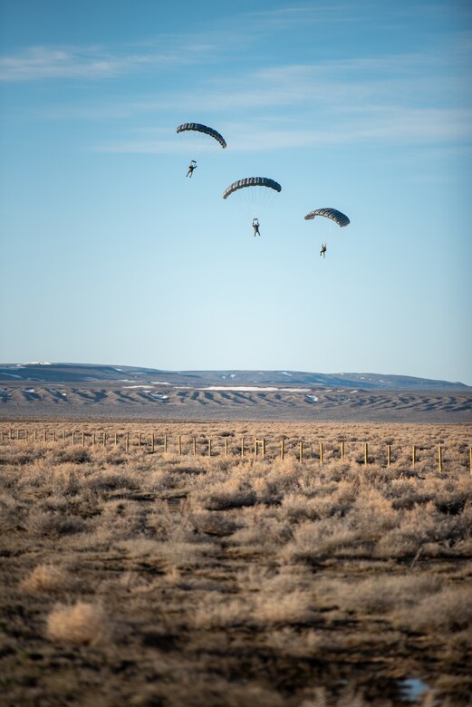 Airmen from the Kentucky Air National Guard’s 123rd Special Tactics Squadron parachute near Highway 287 in Wyoming during Exercise Agile Chariot on April 30, 2023, honing capabilities linked to Agile Combat Employment. Instead of relying on large, fixed bases and infrastructure, ACE employs smaller, more dispersed locations and teams to rapidly move aircraft, pilots and other personnel as needed. Under ACE, millions of miles of public roads can serve as functional runways with Forward Arming and Refueling Points when necessary. (U.S. Air National Guard photo by Master Sgt. Phil Speck)
