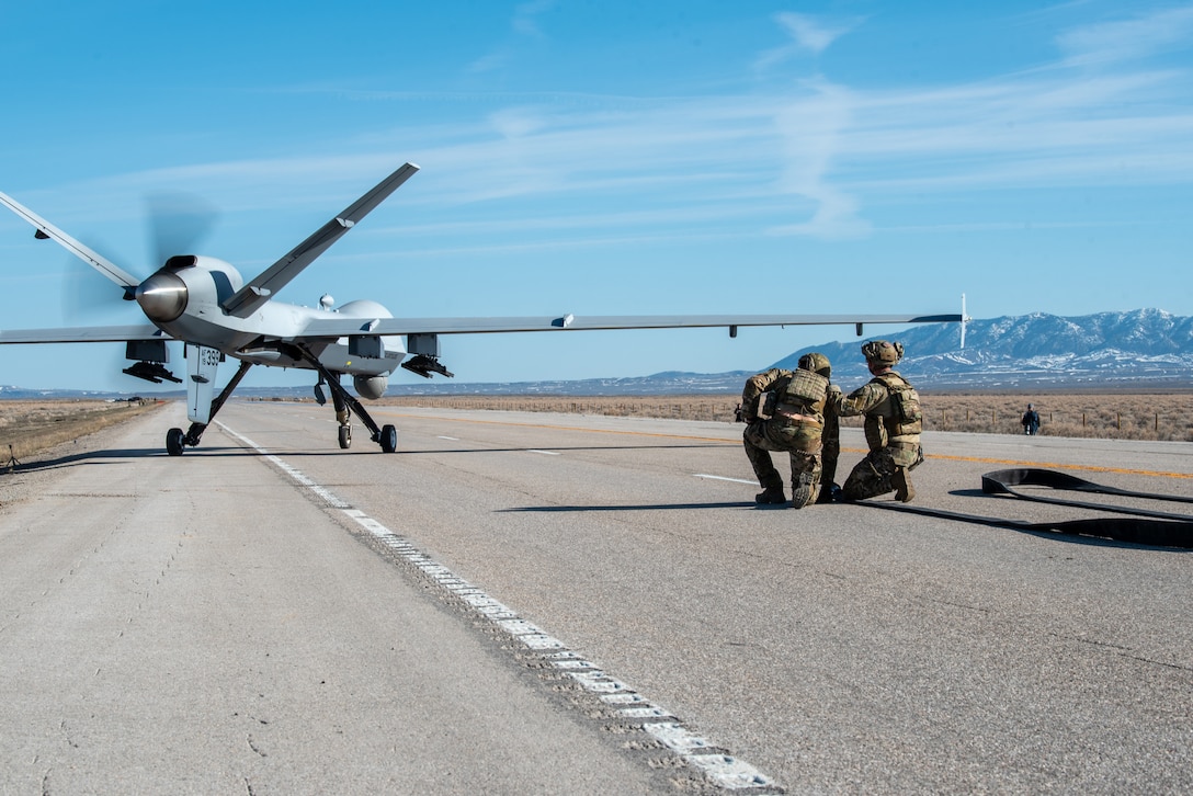 An MQ-9 Reaper prepares to take off from Highway 287 in Wyoming during Exercise Agile Chariot on April 30, 2023, honing capabilities linked to Agile Combat Employment. Instead of relying on large, fixed bases and infrastructure, ACE employs smaller, more dispersed locations and teams to rapidly move aircraft, pilots and other personnel as needed. Under ACE, millions of miles of public roads can serve as functional runways with Forward Arming and Refueling Points when necessary. (U.S. Air National Guard photo by Master Sgt. Phil Speck)